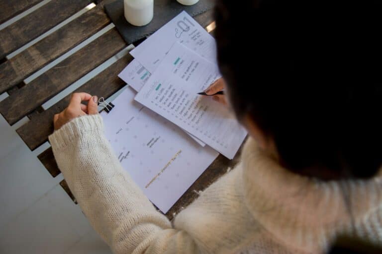 Home 2 153 Business owner reviewing a monthly calendar and task list at a table