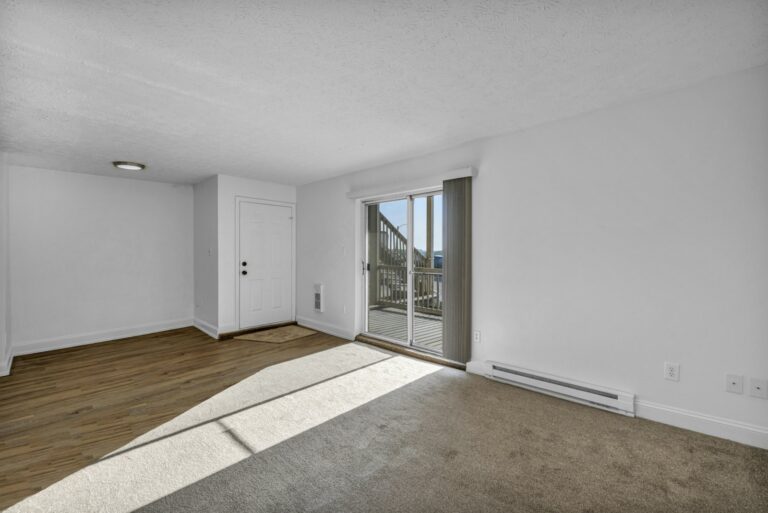 Home 2 152 Empty rental apartment after a tenant moved out, with carpet, wood floor and a sliding glass door